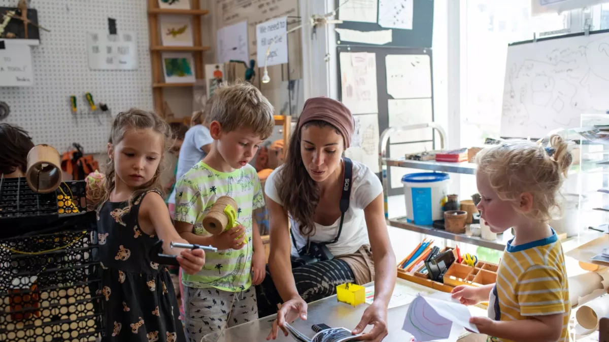 children and a teacher working together