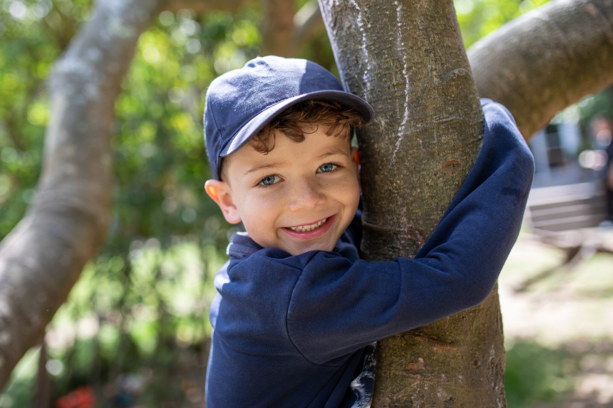 child hugging a tree