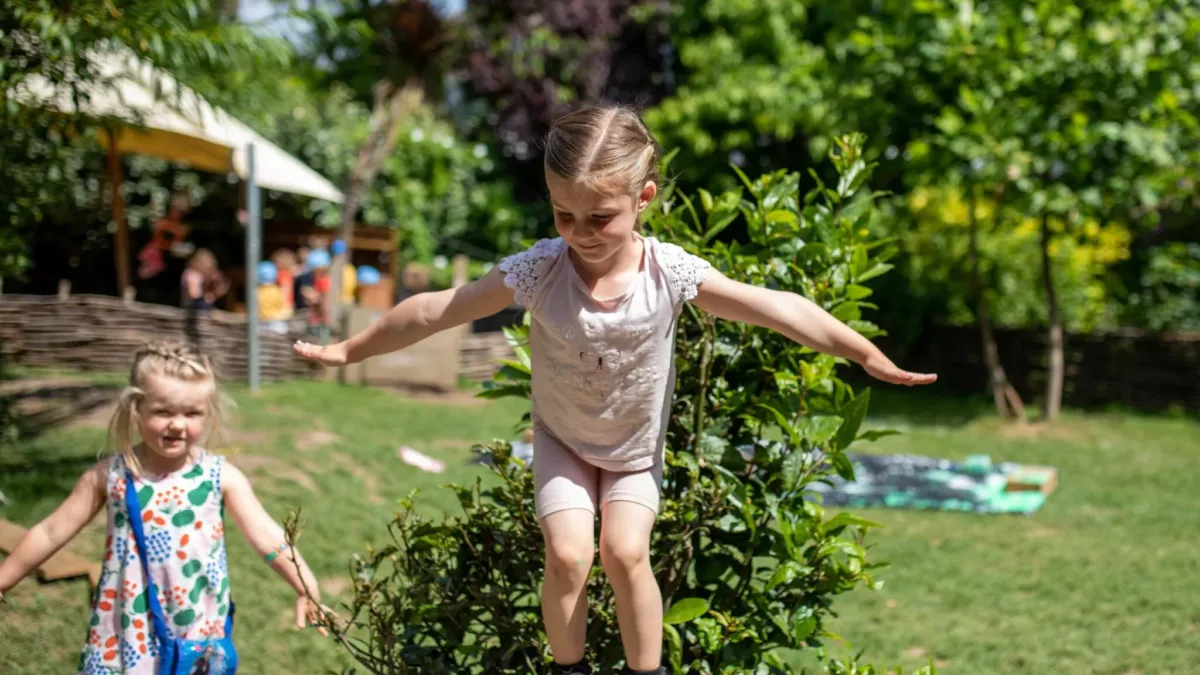 girl stood on a log stump