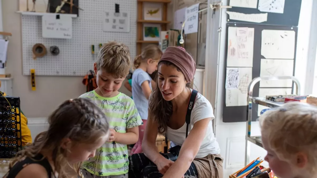 a teacher working with children in the nursery