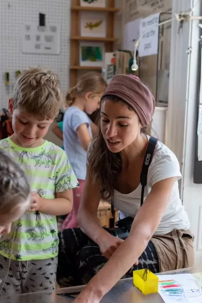 a teacher working with children in the nursery